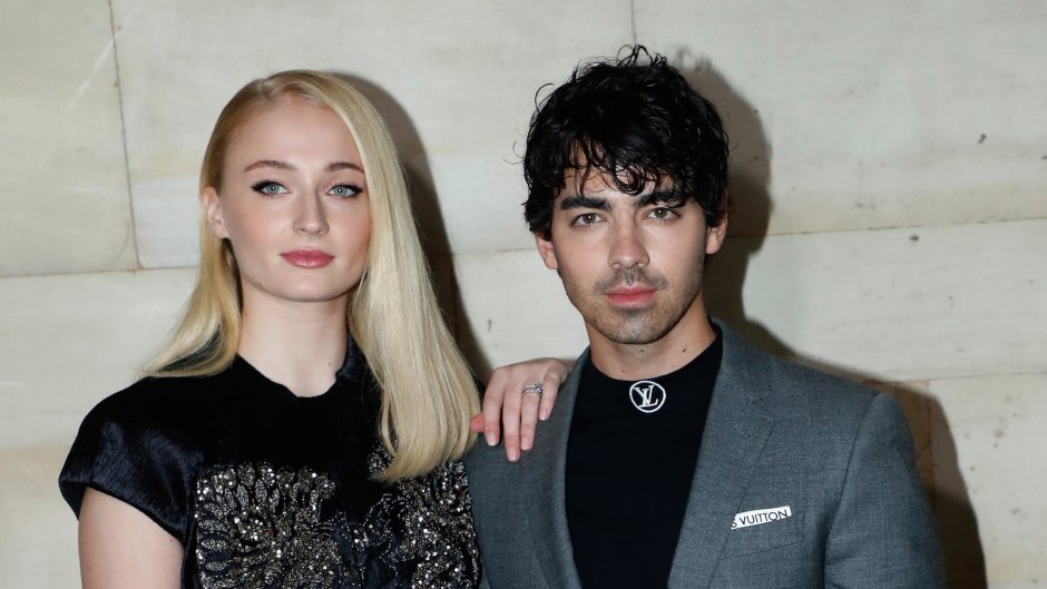 Joe Jonas and Sophie Turner at an event, Sophie wearing a lace black shirt and Joe wearing a suit