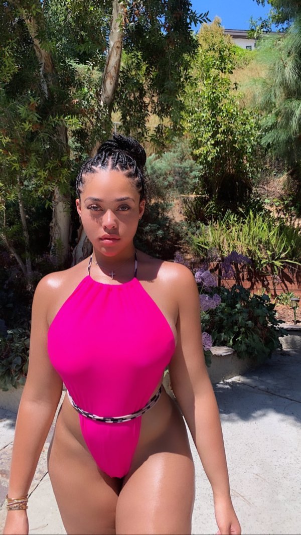 Jordyn Woods Poses in a Revealing Hot Pink Swimsuit Photos