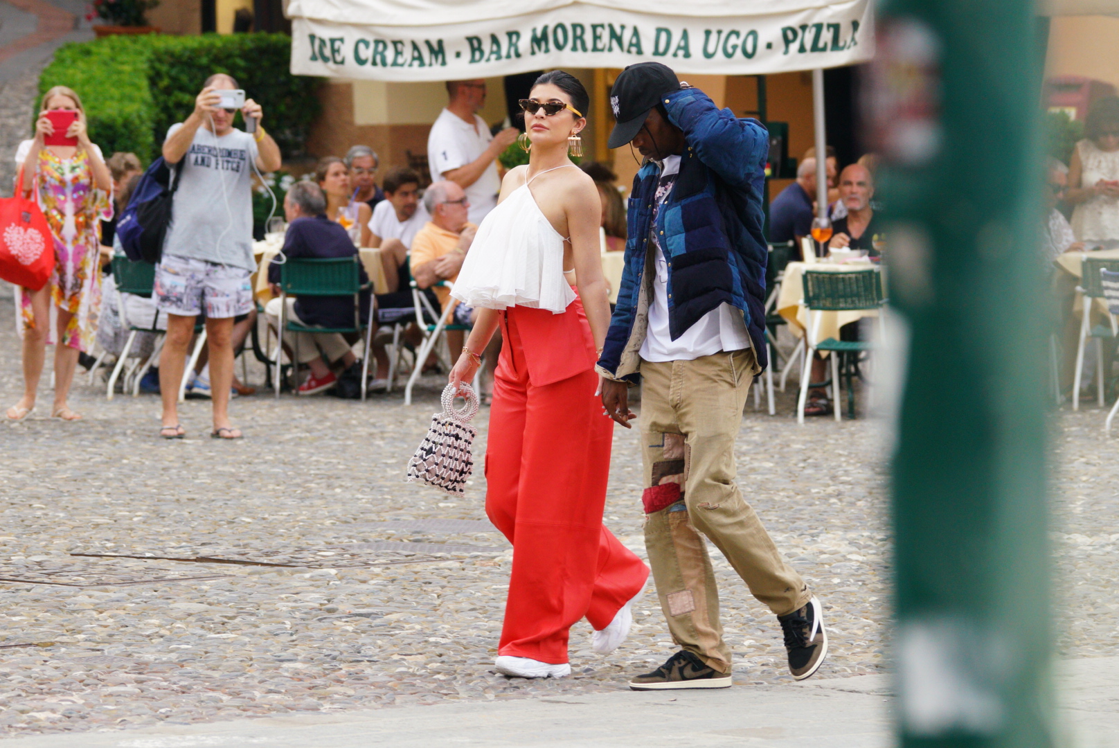 Singer Travis Scott is seen walking with a Louis Vuitton Handbag