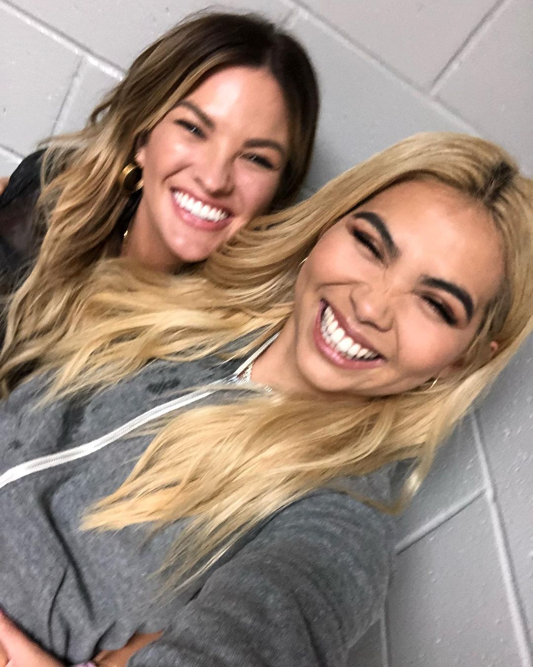 Hayley Kiyoko and Becca Tilley pose hand-in-hand as a stylish