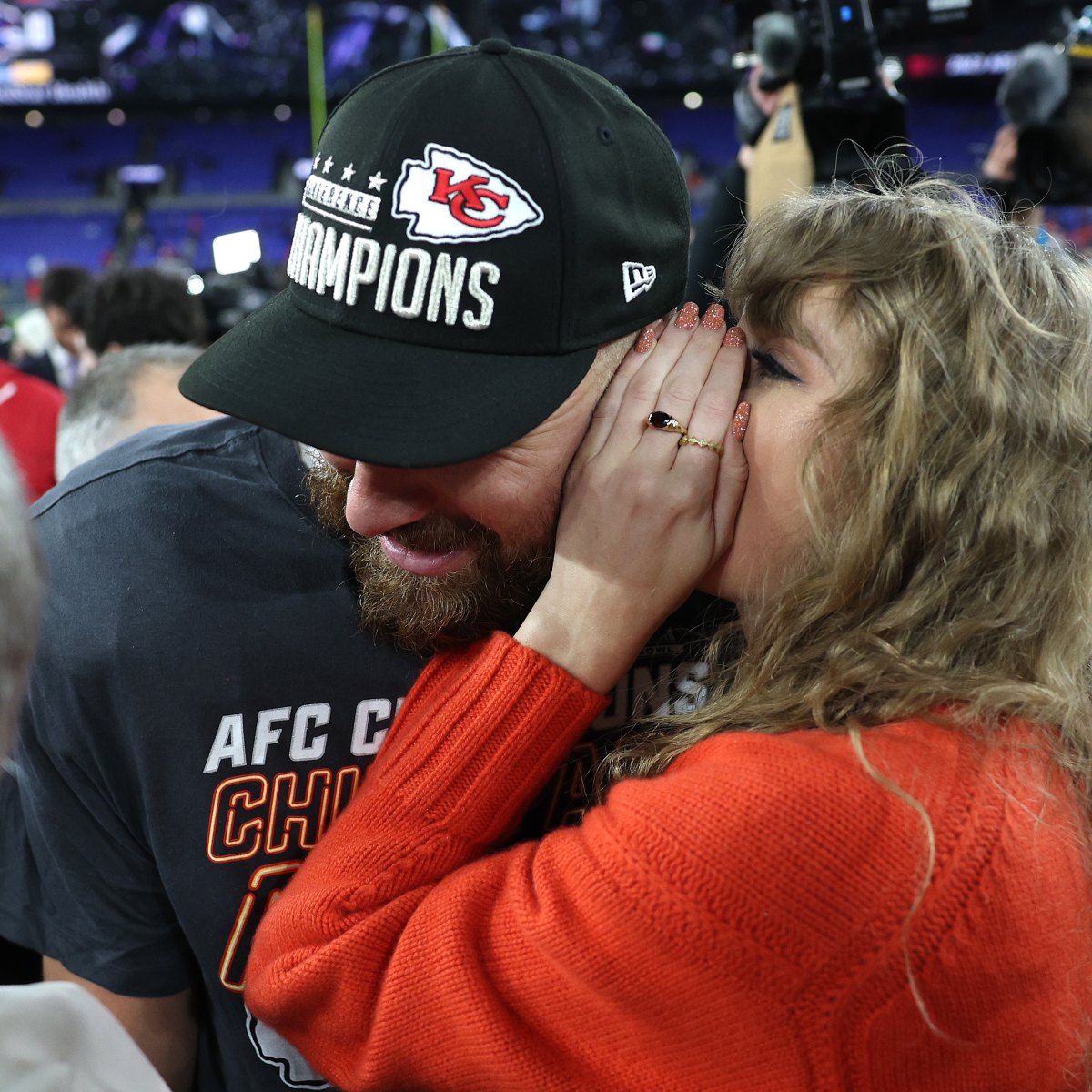 Taylor Swift Kisses Travis Kelce on Field After Playoff Win | Life & Style