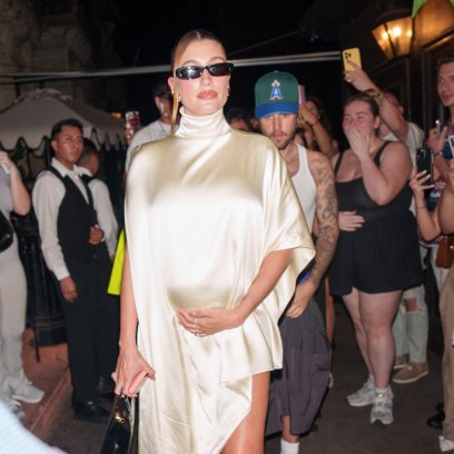 Hailey Bieber Cradles Baby Bump in Satin Dress on Date Night With Justin Bieber: Photos