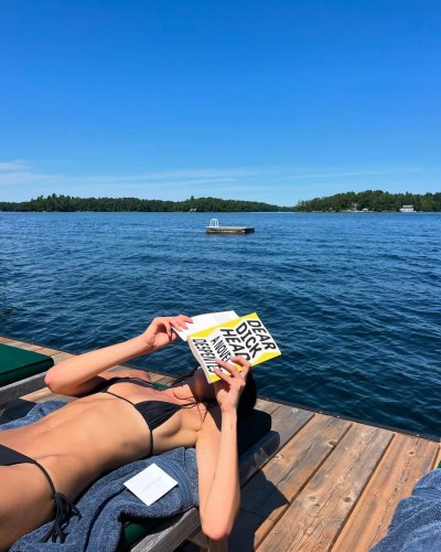 Kaia Gerber Rocks Tiny Black Bikini While Reading ‘Dear D--khead’